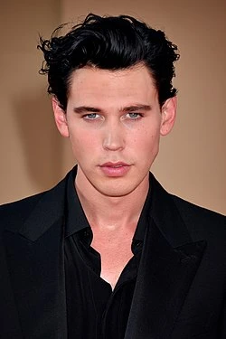 Editorial gallery of Austin Butler styled in cool winter outfits featuring sapphire, amethyst, and inky neutrals, highlighting glacier blue, raspberry, graphite, arctic white, and ultra black.