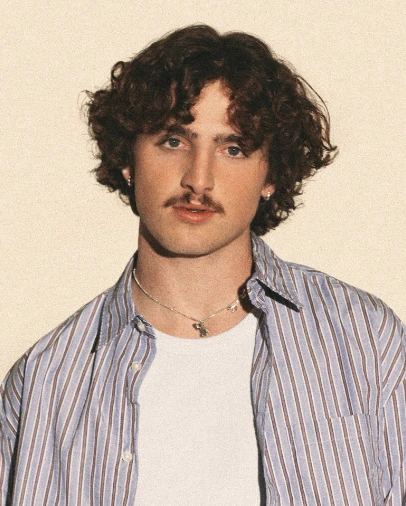 Benson Boone wearing icy pastel tailoring with soft shimmer, showcasing bluebell, lavender mist, storm gray, cool teal, and soft navy from the Cool Summer palette.