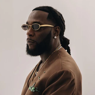 Editorial gallery of Burna Boy styled in vibrant autumn outfits featuring saffron, teal, and gold hardware, highlighting burnt sienna, chartreuse, emerald, molten gold, and espresso.