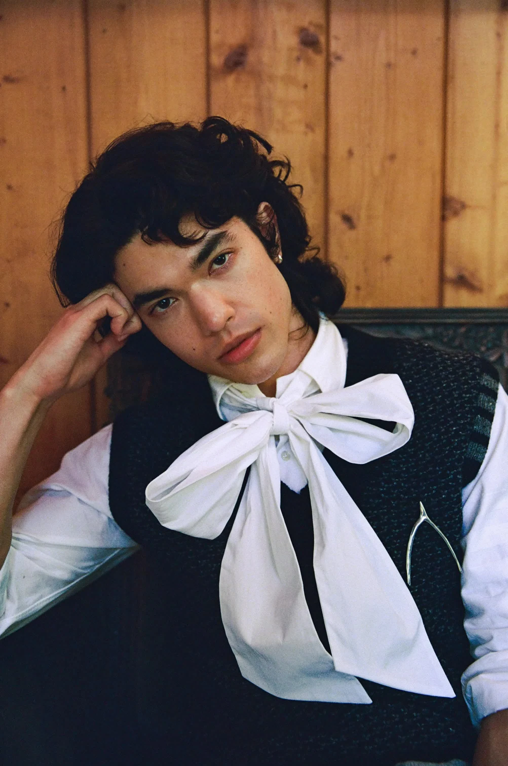 Conan Gray wearing jewel-toned statement dressing with crisp contrast and sparkle, showcasing electric cobalt, icy magenta, optic white, chrome silver, and inky black from the Bright Winter palette.