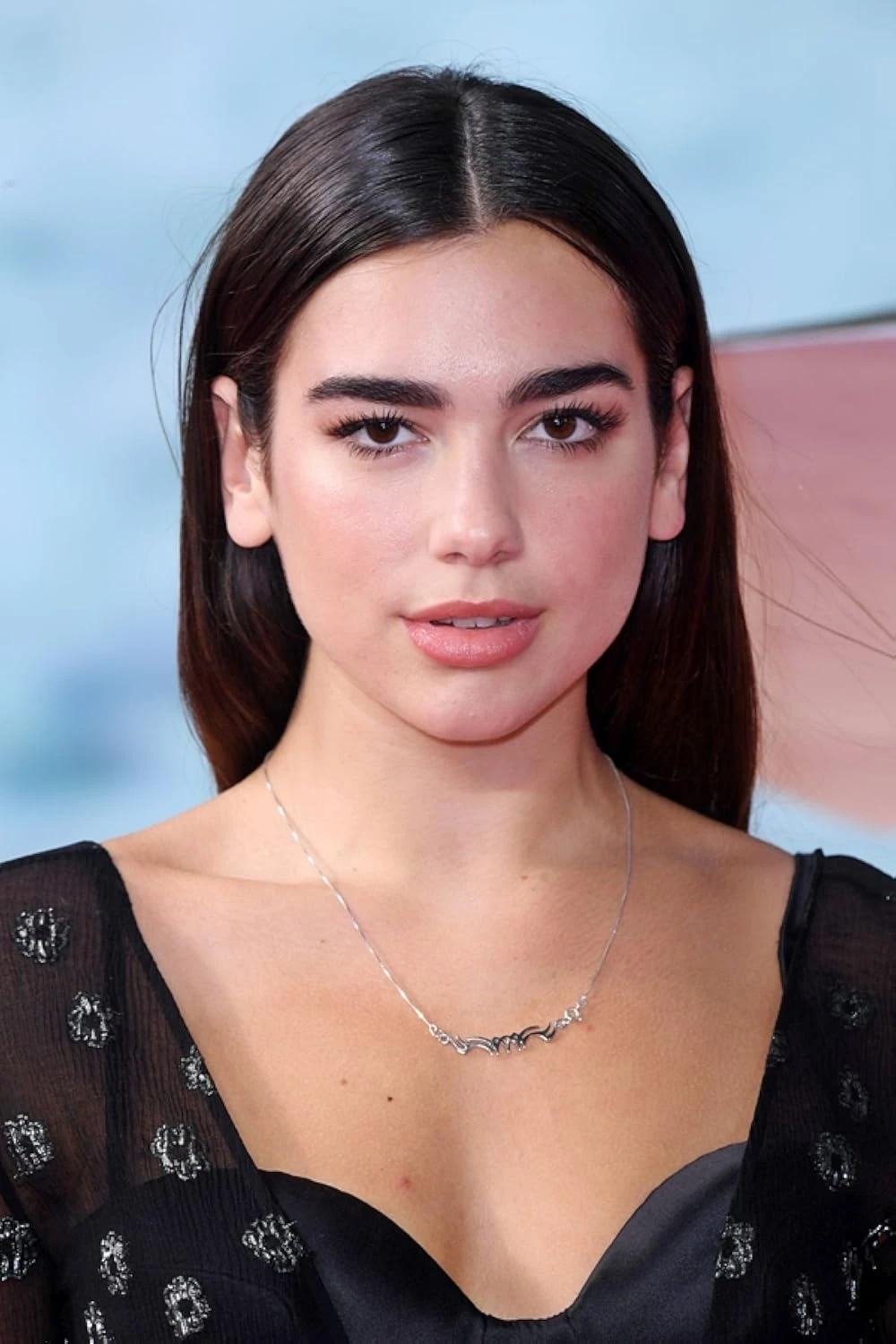 Editorial gallery of Dua Lipa styled in deep winter looks featuring sapphire, garnet, and chrome accents, highlighting electric cobalt, amethyst, gunmetal, crimson, and ultra black.