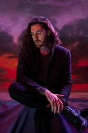 Hozier wearing jewel-toned statement dressing with crisp contrast and sparkle, showcasing electric cobalt, icy magenta, optic white, chrome silver, and inky black from the Bright Winter palette.