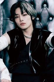 Editorial gallery of I.N (Stray Kids) styled in bold winter ensembles mixing neon pops, inky black, and chrome sparkle, highlighting ultra violet, neon fuchsia, electric jade, polished pewter, and onyx.