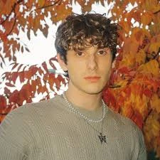 Editorial gallery of JVKE styled in soft autumn looks mixing moss green, terracotta, and bronzed neutrals, highlighting desert rose, sage green, oatmeal, copper brown, and soft teal.