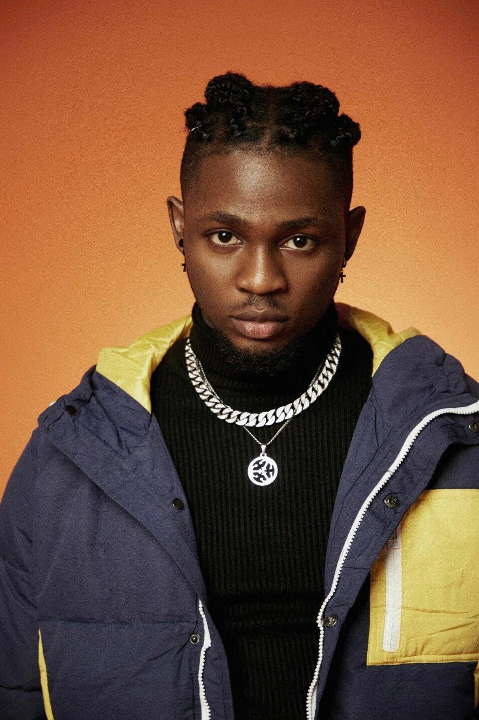 Editorial gallery of Omah Lay styled in vibrant autumn outfits featuring saffron, teal, and gold hardware, highlighting burnt sienna, chartreuse, emerald, molten gold, and espresso.