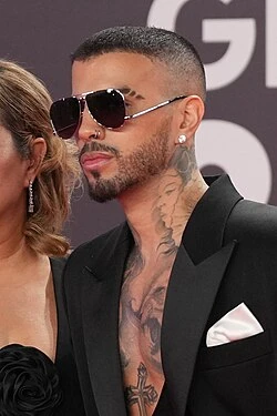 Editorial gallery of Rauw Alejandro styled in soft summer outfits blending dusty mauve, mist blue, and slate neutrals, highlighting heather gray, dusty mauve, mist blue, slate green, and antique silver.