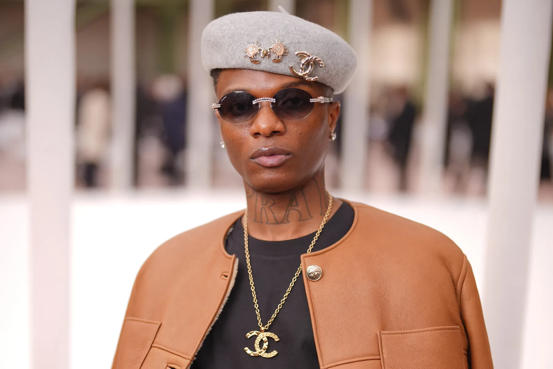 Wizkid wearing sun-soaked autumn looks with rich neutrals and texture, showcasing amber, rust, olive, bronze, and cream from the Warm Autumn palette.