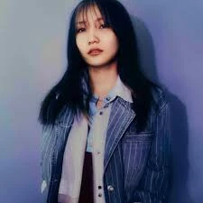 Editorial gallery of YOASOBI (Ikura) styled in soft autumn looks mixing moss green, terracotta, and bronzed neutrals, highlighting desert rose, sage green, oatmeal, copper brown, and soft teal.